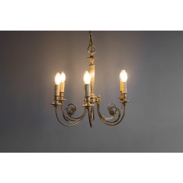 Six arm brass chandelier. Re-wired and tested. Circa 1930. Up to 250V (Europe/UK Standard).The wiring of this item may be...