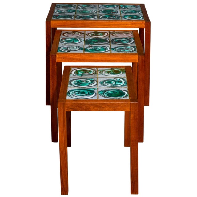 I love this set. It is a set of 1960s Danish modern nesting tables with beautiful hand crafted tile inset. The tiles are a...