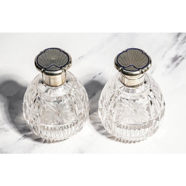 An elegant matched pair of antique English crystal perfume bottles, these refined vanity accessories beautifully capture...