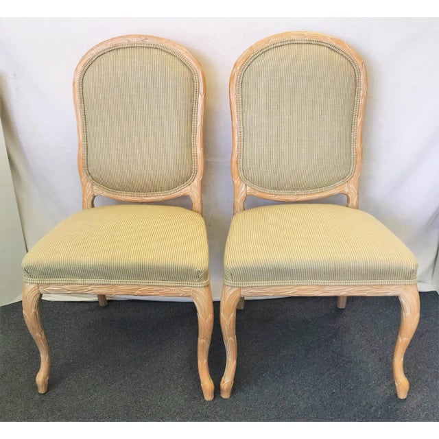 Beautiful pair of Italian wheat sheath chairs in the style of Serge Roche. The carved wood frames have a wheat sheath...