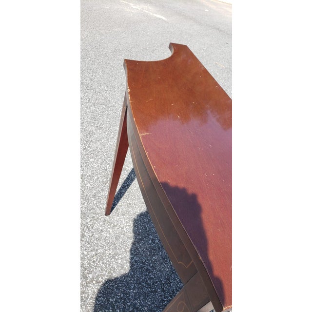 An elegant Federal-style demi lune console table from the highly collectible Historic Charleston Collection by Baker...
