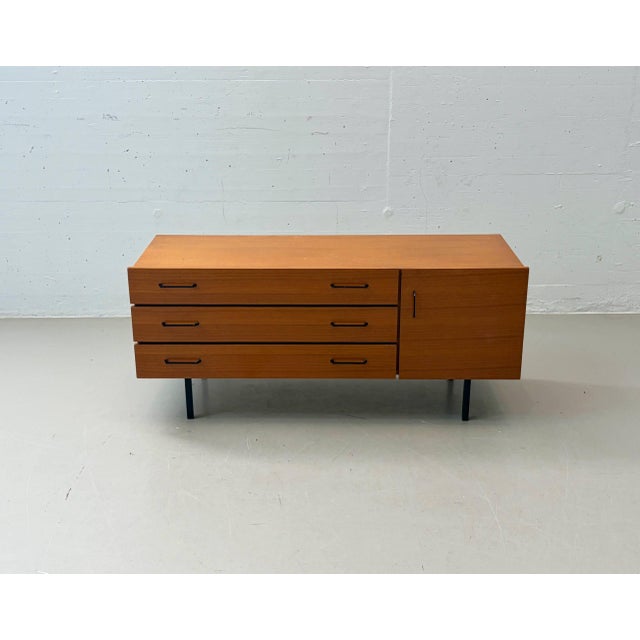 Elegant mid-century sideboard/lowboard with a clean, minimalist design. The piece impresses with its warm teak veneer,...