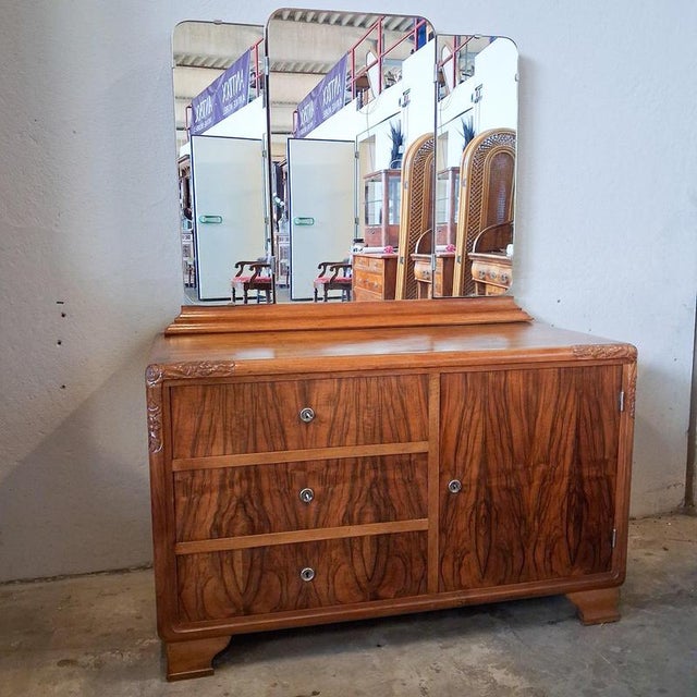 Elegant art deco dresser/vanity table with a three-panel folding mirror and ample storage space. Distinctive walnut grain,...