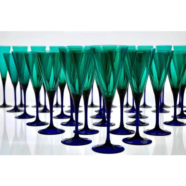 A complete ensemble of thirty-six mouth-blown glasses, comprising twelve flutes, twelve wine glasses, and twelve water...