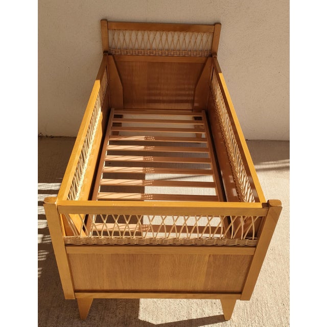 Vintage 1950s/60s children's bed in light pine wood with rattan trim, sleeping area 60 x 120 cm, new (not original)...