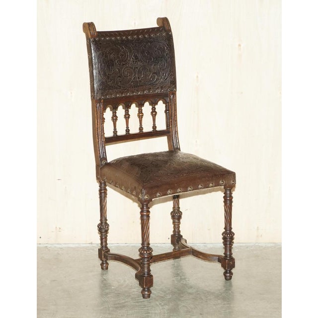 We are delighted to offer for sale this exceptional set of six French oak with Embossed pressed brown leather upholstered...