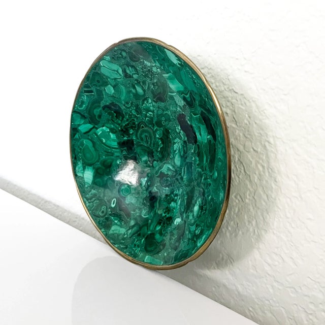 A truly elegant accent dish crafted of the semiprecious gemstone malachite, complimented by a brass metal rim. Substantial...
