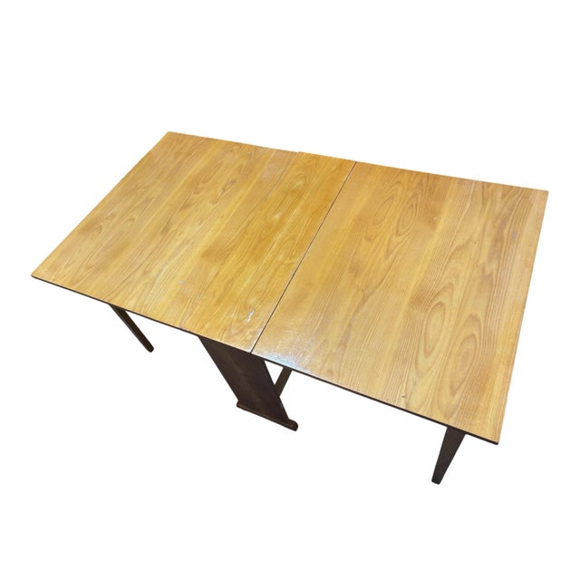 The MCM Drop Leaf Table by Kapsukas Furniture Lithuania is a stylish and unique dining table with a mid-century modern...