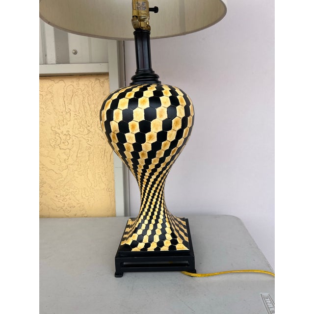 This lamp is a table lamp featuring a black and yellow "tumbling block" or chevron geometric pattern. Featuring a distinct...