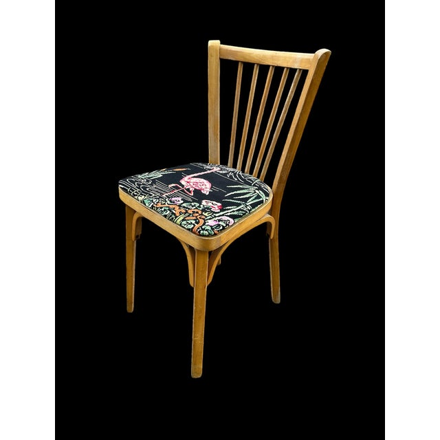 Baumann beechwood chair, 1950s The chair has been reupholstered with vintage flamingo print fabric This piece has an...