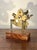 A handsome antique brass nautical sextant mounted on a custom hardwood display stand, offering the timeless appeal of...