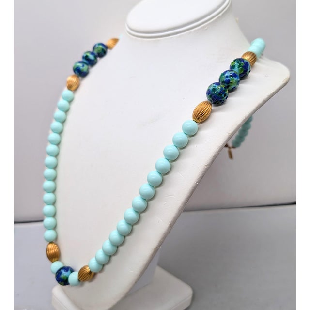 1960s goldtone single strand pale green spherical beads with goldtone ribbed ellipse shaped beads with single spherical...
