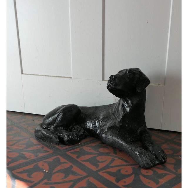 A Black Labrador Puppy, Door Stop A charming piece for all dog lovers, he or she is made in cast iron and in a resting...