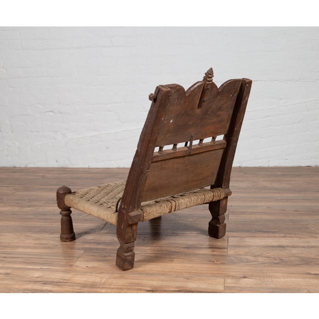 Early 20th Century Antique Indian Rustic Low Seat Wooden Chair with Carved Rosettes and Twine Seat For Sale - Image 5 of 12