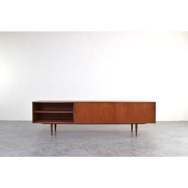 A long teak sideboard designed in the spirit of Scandinavian modernism combines functionality with a balanced, timeless...