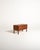 Scandinavian low teak sideboard from the 1960s, with two doors, a brass lock, and a frame base with square legs....