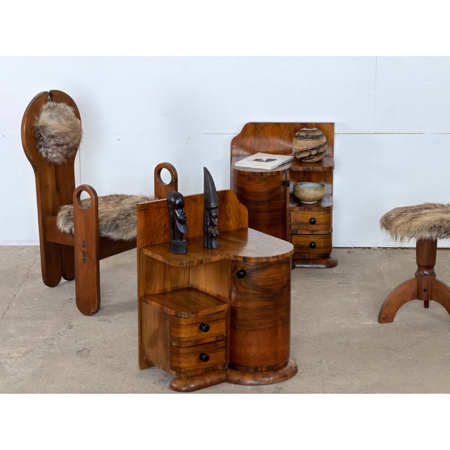 Pair of European Art Deco bedside tables in figured walnut veneer, 1930s. The two are built as a mirrored pair, one for...