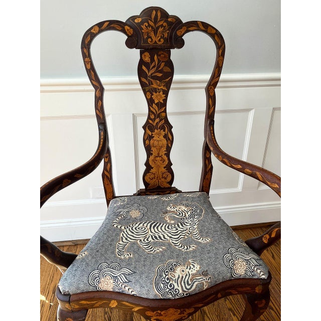 19th century Dutch Marquetry Armchair. Fine scalloped crest rail over a shaped seat. Newly reupholstered seat over...
