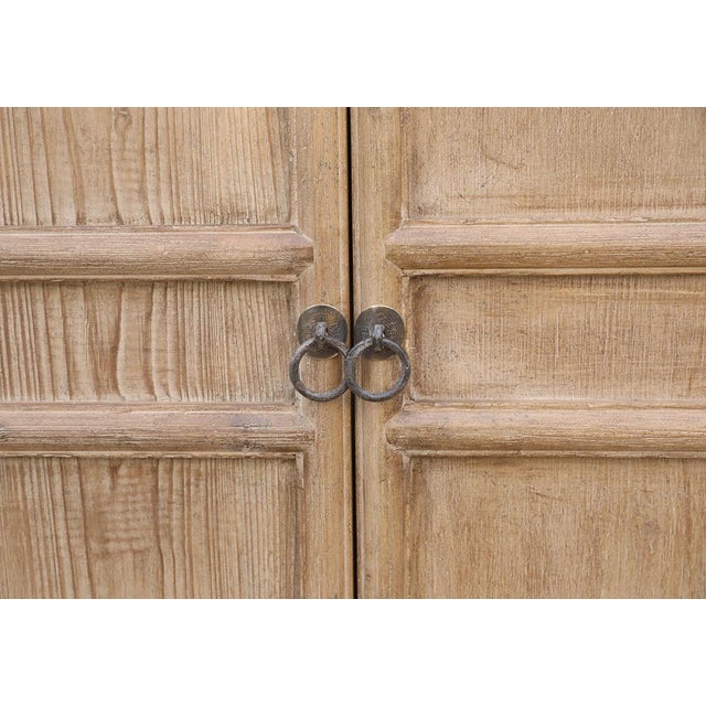 A beautifully understated antique Chinese cabinet crafted from solid pine, dating to the late Qing dynasty. The long...