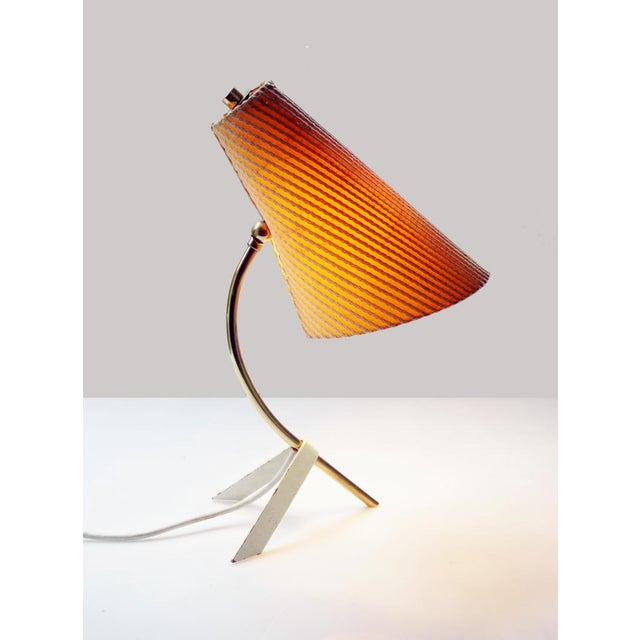 Elegant mid-century modernist tripod desk light on a brass frame. Made by Nikoll, Austria, 1950s. Lighting: takes one...