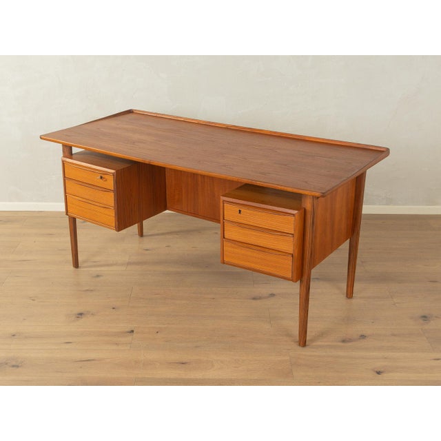 A wonderful desk by Peter Løvig Nielsen from the 1960s. High-quality teak veneer frame with six drawers, a floating...