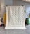 A refined Moroccan M’rirt rug featuring a sculptural geometric pattern in soft ivory and natural beige. Its composition of...