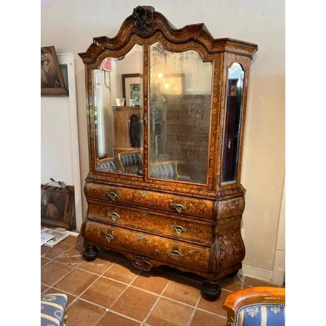 This is a very nice 19th century Dutch marquetry hand carved mahogany Bookcase cabinet. The cabinet is decorated with...