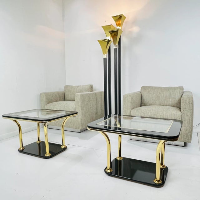 Large art deco torchiere floor lamp featuring 4 ebonized metal pedestals with brass flared up-shades and lucite accents....