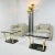Large art deco torchiere floor lamp featuring 4 ebonized metal pedestals with brass flared up-shades and lucite accents....