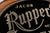 Antique reverse-painted glass and silver-foil advertising sign for Jacob Ruppert's Beer of New York. The oval sign...