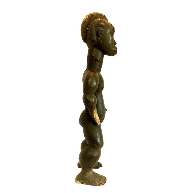 This standing male figure is a traditional African power or ancestral sculpture. The bared, pointed teeth and stylized...