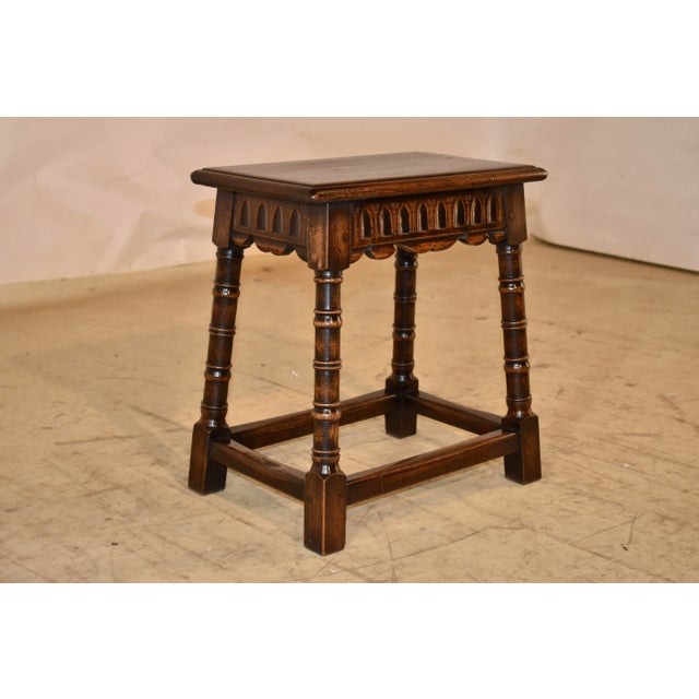 19th century oak joint stool from England. The top has a beveled edge, following down to a hand carved decorated and...