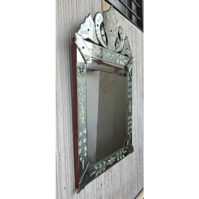 Exquisite Venetian mirror with beautiful hand etched designs throughout. The mirror features a stunning rectangular centre...