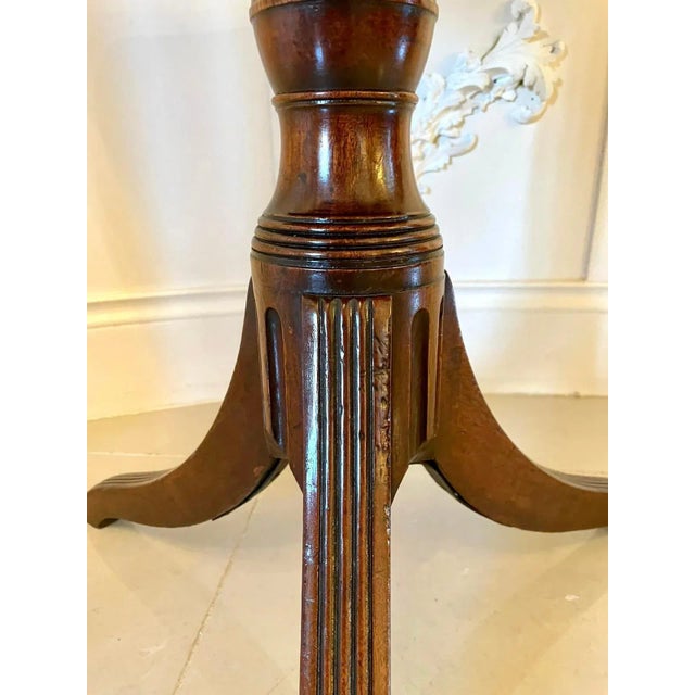 Antique mahogany regency tripod table having a quality mahogany tilting top with a reeded edge supported by a shaped...