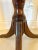 Antique mahogany regency tripod table having a quality mahogany tilting top with a reeded edge supported by a shaped...