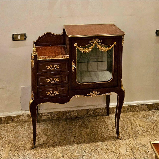 Exquisite Louis XV style bedside cabinet, beautifully crafted with elegant marquetry and a rich, polished wood finish....