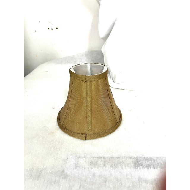 Camel color faux silk small lampshade. Perfect for candlestick lamps and chandeliers. Measure 6” diameter at bottom, 3”...