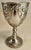 This is a very decorative single silver plate stem with an raised pair of cherubs draping a ribbon around what could be an...