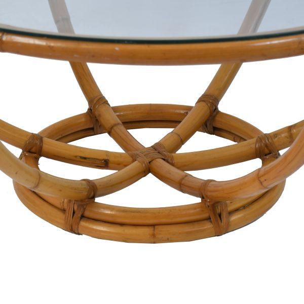 A large round rattan coffee table that anchors a sitting area with warm, natural texture. The round silhouette keeps...