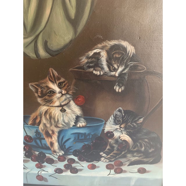 The oil painting is signed by the artist, L.Chaffee and it is dated 1905. The kittens are playing with cherries that are...