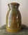 Artist-signed glazed pottery vase featuring an olive green and brown reactive glaze with subtle ochre and blue-green...