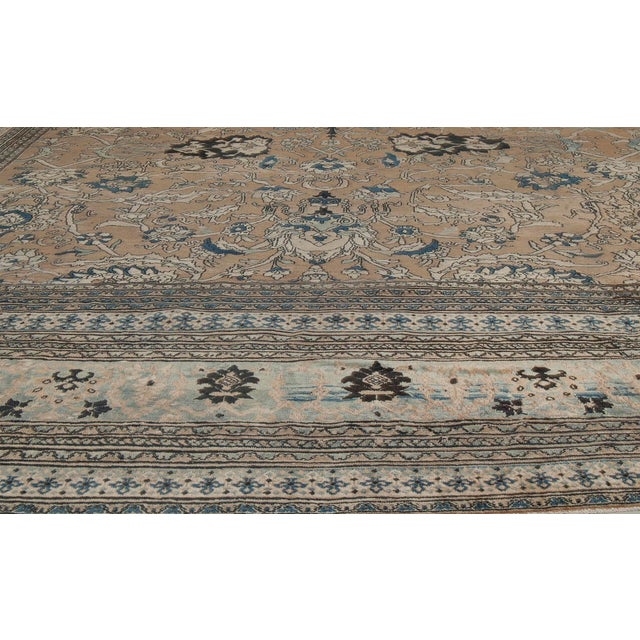 An early 20th century antique Khorassan rug from Northeast Persia, the abrashed camel field with a voluptuous trellis...