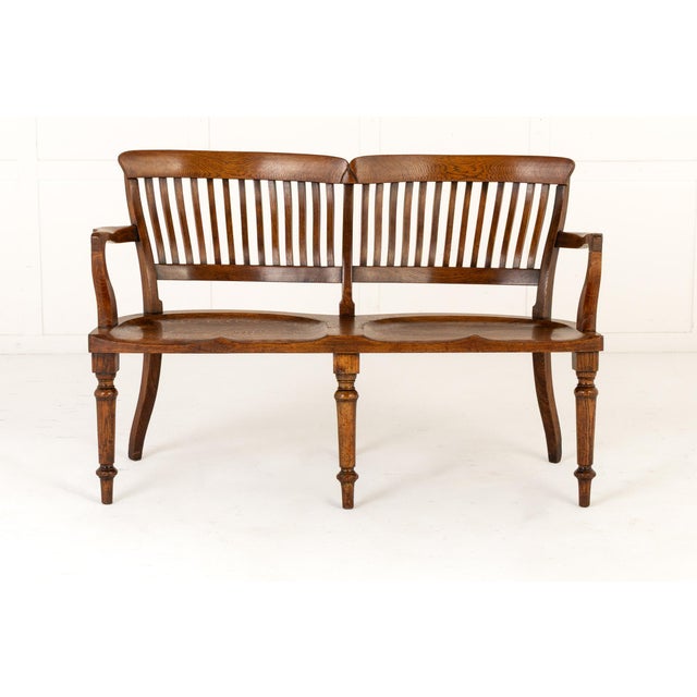 A late 19th century english oak double chair-back settee. of unusual double chair-back form, the settee/bench has two...