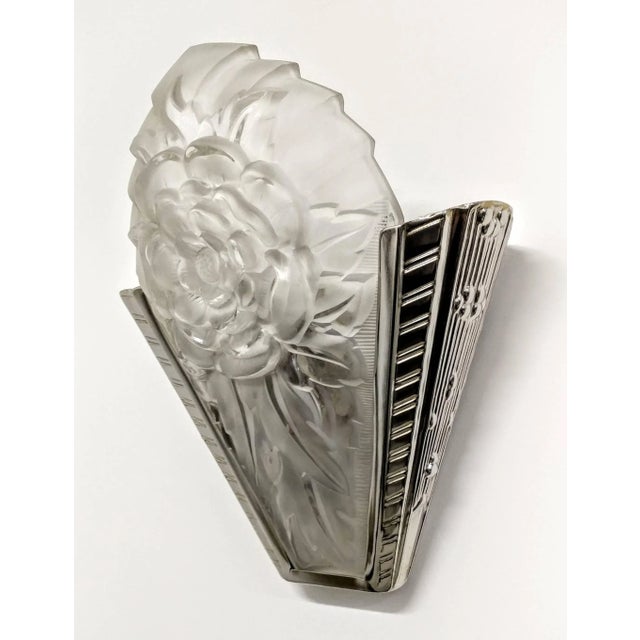 A pair of French Art Deco wall sconces was Signed by the French artist "David Gueron Degue" known as Degue. Molded clear...