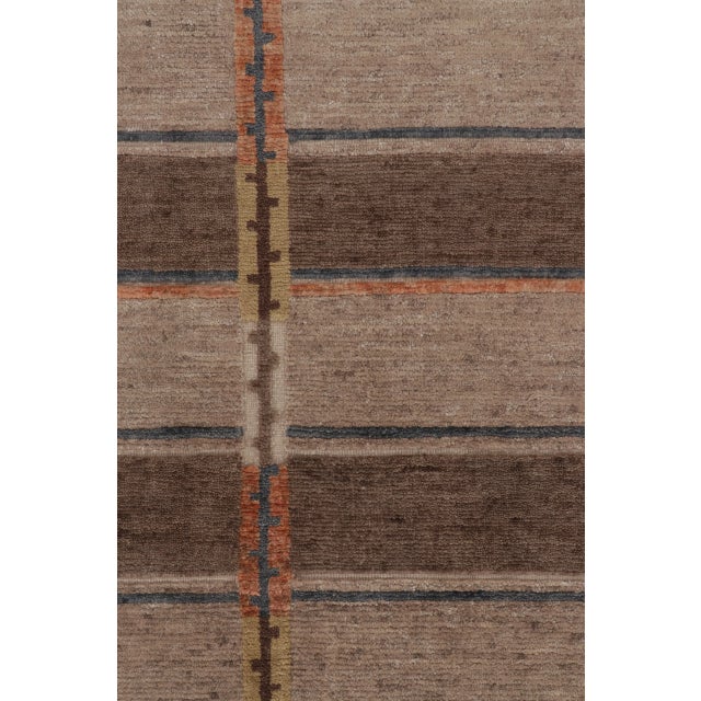 Hand-knotted in premium wool, this 9x11 contemporary Scandinavian rug features a warm earthy geometric grid framed by...