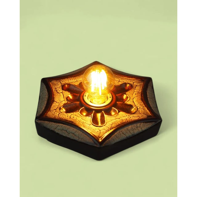 A pair of Pan Leuchten ceramic sconces that combine a sculptural form with a warm, amber glow. Featuring a brilliant "fat...