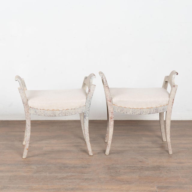 This lovely pair of Swedish pine stools or tabourets have gently curved, saber legs which add an elegant touch to the...