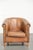 This sturdy sheepskin club armchair in a light cognac color, finished with decorative nails. : This sturdy sheepskin club...