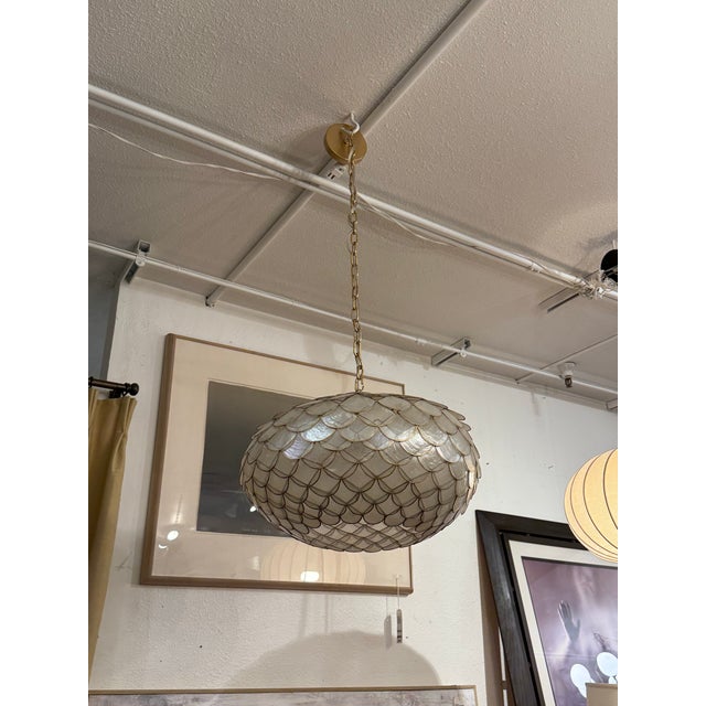 Design Plus Gallery presents a Capiz Scalloped Chandelier by Serena & Lily. This chandelier has a rounded dome form...