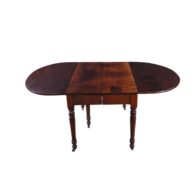 Antique 19th Century drop leaf extendable Console, breakfast or dining table, circa 1870s. Made from American cherry with...